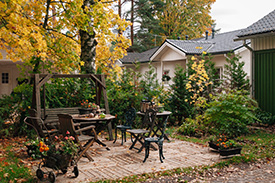 Backyard patio and garden where homeowners should check for standing water that can breed mosquito larvae
